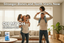 Family with children in a living room, promoting stronger bones and teeth with using OH MY OH Calcium and vitamin D3 Gummies